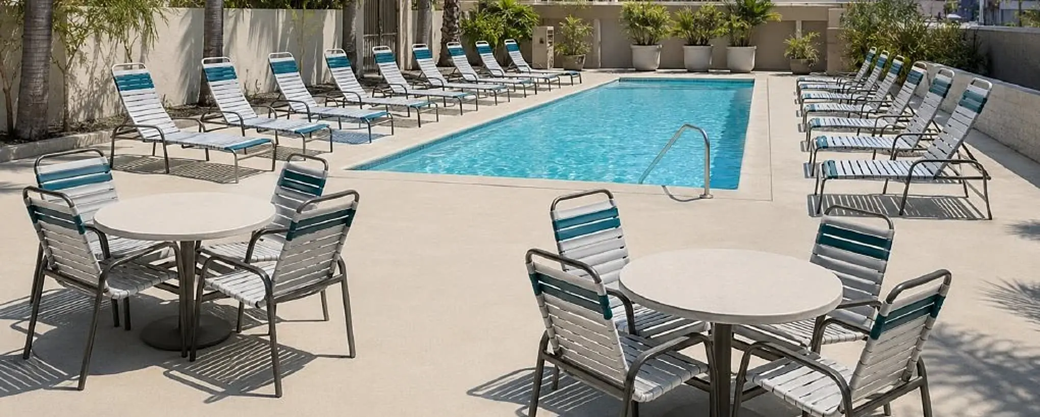 Alta vinyl chaise lounges and dining seating at a hotel pool in the approved Cievaro catalog