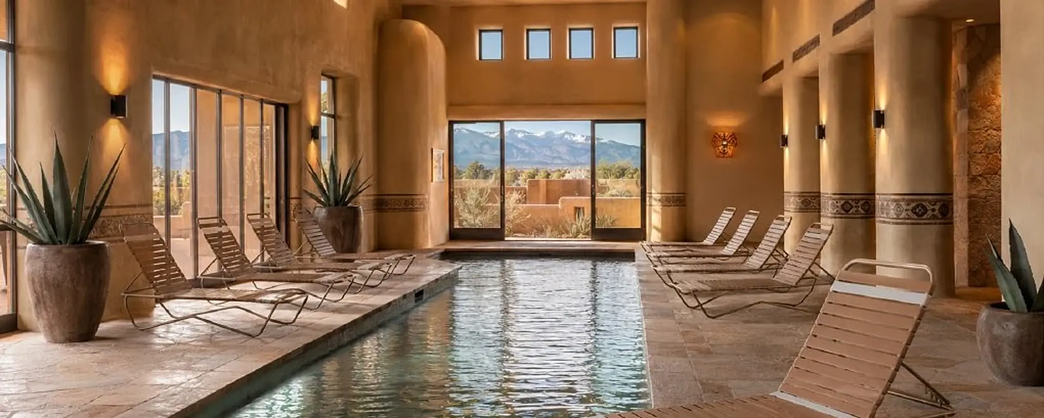 Avra vinyl strap chaise lounges arranged beside an indoor pool in the approved Cievaro catalog setting