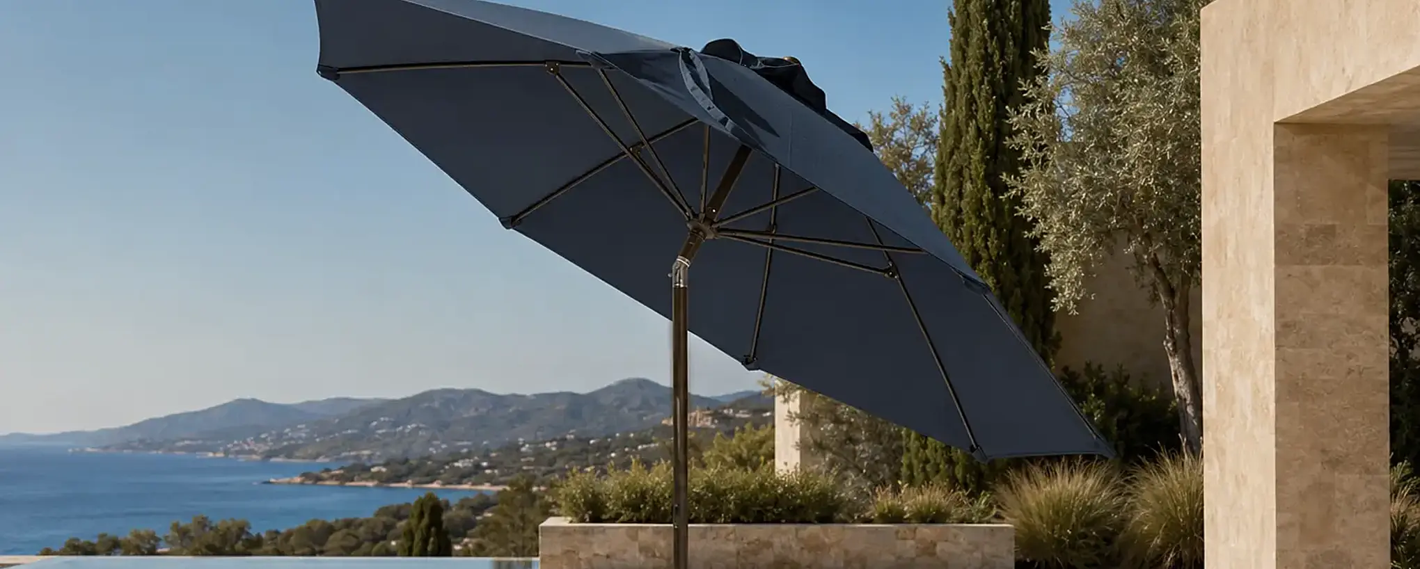 Solea commercial umbrella providing shade beside a luxury pool with a coastal view