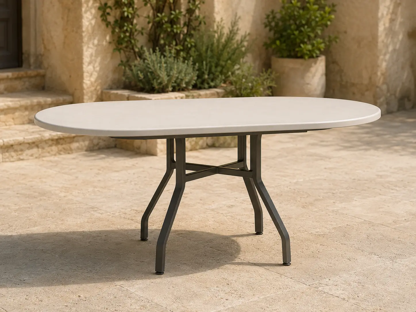 Tavola Pranzo 44 × 72 Heavy-Duty Oval Table shown in a refined outdoor setting