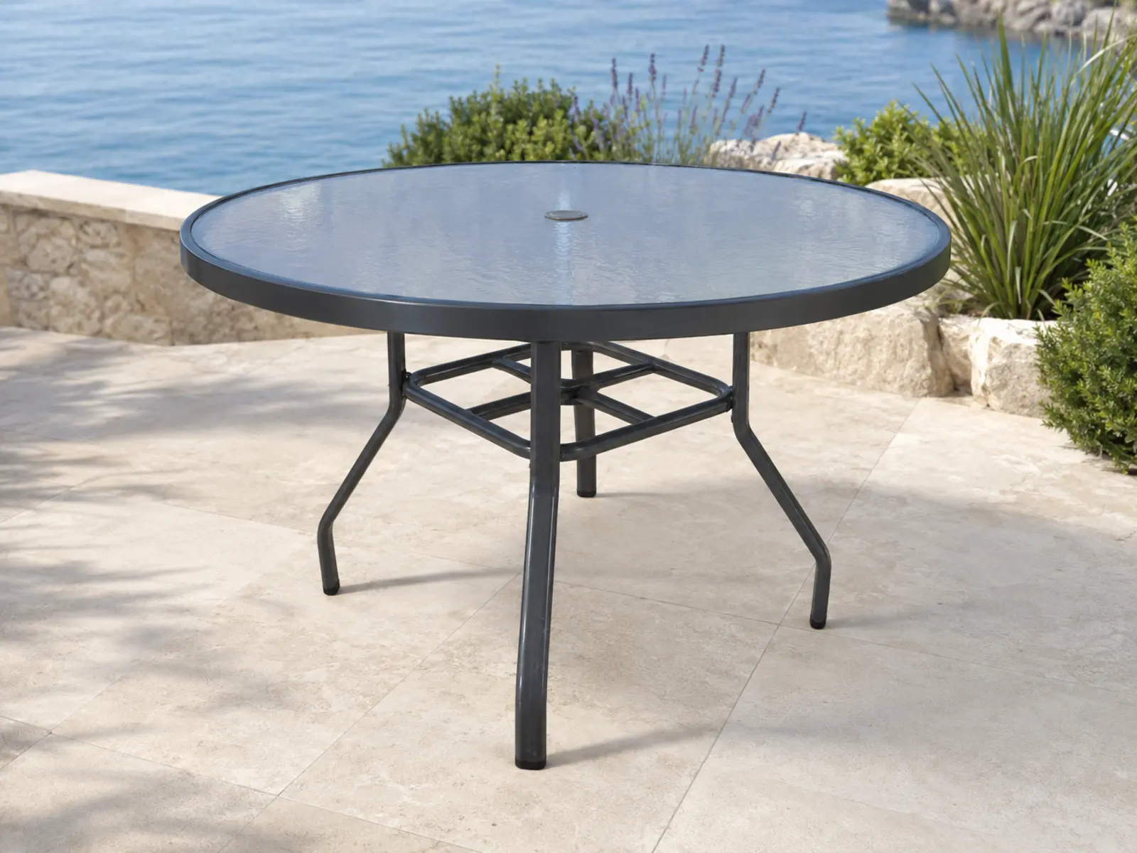 Tavola Pranzo 48 Umbrella Dining Table shown in a refined outdoor setting